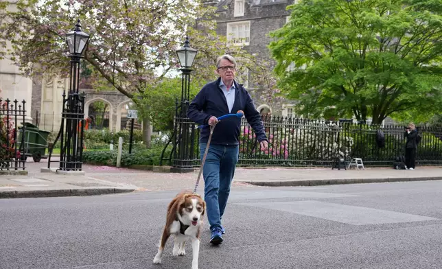 Peter Mandelson is seen with his dog outside his home in London, Monday, April 20, 2026 as Britain's Prime Minister Keir Starmer is facing a showdown in Parliament over the appointment of Peter Mandelson as ambassador to Washington.(AP Photo/Kin Cheung)