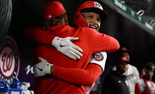 Washington Nationals' CJ Abrams, front right, celebrates after his home run in the dugout during the eighth inning of a baseball game against the St. Louis Cardinals, Monday, April 6, 2026, in Washington. (AP Photo/Nick Wass)