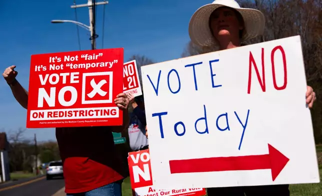 Kasey Griffin, right, and other members of the Madison County Republican Committee wave signs opposing the Virginia redistricting referendum at passing cars, during the early voting period, Friday, April 3, 2026, in Madison, Va. (AP Photo/Julia Demaree Nikhinson)