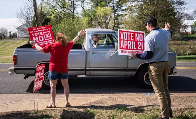 A truck driver stops to wave at members of the Madison County Republican Committee as they hold signs opposing the Virginia redistricting referendum, during the early voting period, Friday, April 3, 2026, in Madison, Va. (AP Photo/Julia Demaree Nikhinson)