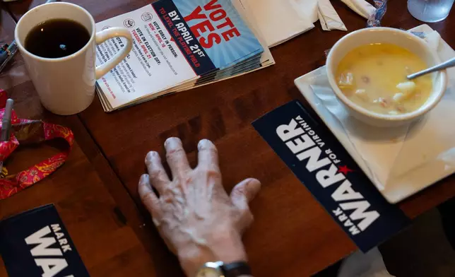 Fliers lay on a table as members of the Goochland Democratic Committee Jen Strozier, Doug Mock, Chris Svoboda, Richard Grebe and Judi Sheppard hold a lunch meeting on future get-out-the-vote efforts for the Virginia redistricting referendum, Thursday, April 2, 2026, at GG's Pizza in Maiden, Va. (AP Photo/Julia Demaree Nikhinson)