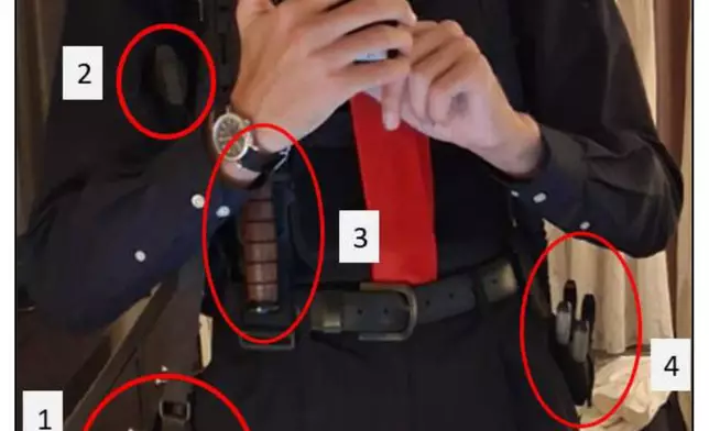 This enhanced version of an image contained in a court filing by the Department of Justice, April 29, 2026, shows Cole Tomas Allen, inside his hotel room, on Saturday, April 25, 2026 in Washington, using his cellphone to take a photograph of himself in the mirror. (Department of Justice via AP)