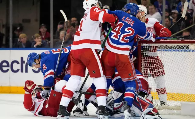 New York Rangers left wing Will Cuylle (50) fights with Detroit Red Wings center Andrew Copp (18), and Rangers center Noah Laba (42) fights with Red Wings left wing James van Riemsdyk (21) during the second period of an NHL hockey game, Saturday, April 4, 2026, in New York. (AP Photo/Yuki Iwamura)