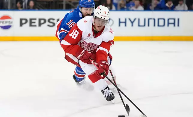 Detroit Red Wings center Andrew Copp (18) fights for control of the puck with New York Rangers center Vincent Trocheck (16) during the second period of an NHL hockey game, Saturday, April 4, 2026, in New York. (AP Photo/Yuki Iwamura)