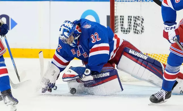 New York Rangers goaltender Jonathan Quick (32) stops the puck during the second period of an NHL hockey game against Detroit Red Wings, Saturday, April 4, 2026, in New York. (AP Photo/Yuki Iwamura)