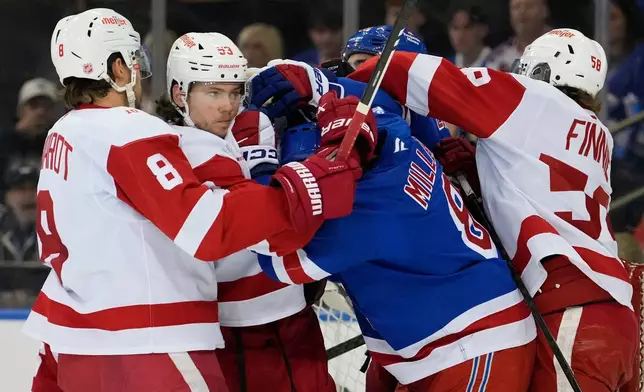 Detroit Red Wings defenseman Moritz Seider (53) fights with New York Rangers center J.T. Miller (8) during the first period of an NHL hockey game, Saturday, April 4, 2026, in New York. (AP Photo/Yuki Iwamura)