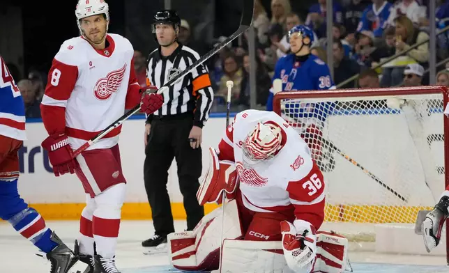 Detroit Red Wings goaltender John Gibson (36) covers the puck during the first period of an NHL hockey game against New York Rangers, Saturday, April 4, 2026, in New York. (AP Photo/Yuki Iwamura)