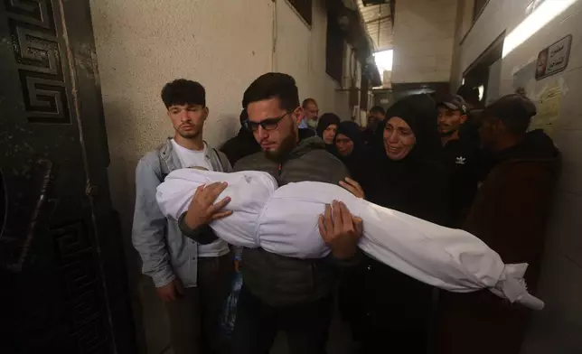 Palestinians mourn over Al-Tanani family killed in an Israeli strike, during their funeral at Al-Shifa Hospital in Gaza City Saturday, April 25, 2026. (AP Photo/Yousef Alzanoun)