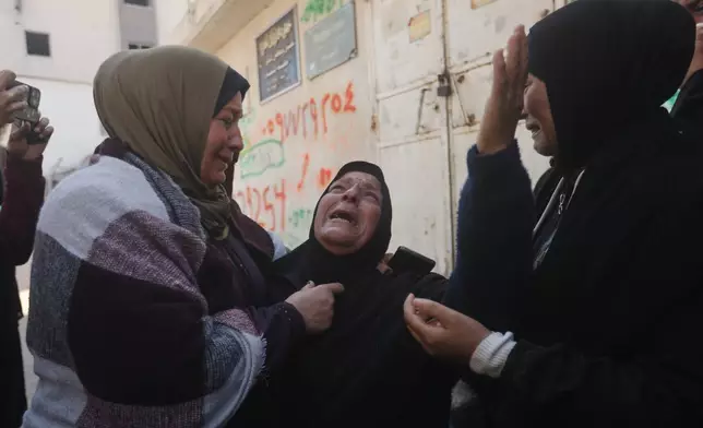 Palestinians mourn over people killed in an Israeli strike during their funeral at Al-Shifa Hospital in Gaza City Saturday, April 25, 2026. (AP Photo/Yousef Alzanoun)
