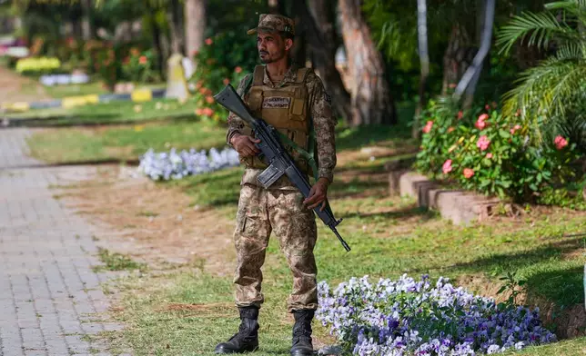 An army soldier stands guard on a roadside to ensure security ahead of the second round of negotiations between the U.S. and Iran, in Islamabad, Pakistan, Monday, April 20, 2026. (AP Photo/Anjum Naveed)