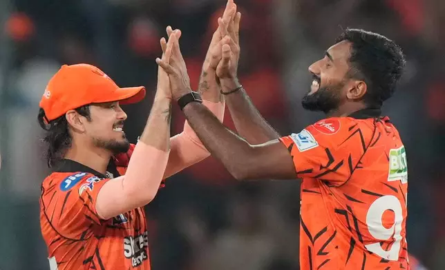Sunrisers Hyderabad's Eshan Malinga, right, and Sunrisers Hyderabad's captain Ishan Kishan celebrates the wicket of Delhi Capitals' Nitish Rana during the Indian Premier League cricket match between Sunrisers Hyderabad and Delhi Capitals in Hyderabad, India, Tuesday, April 21, 2026. (AP Photo/Mahesh Kumar A.)