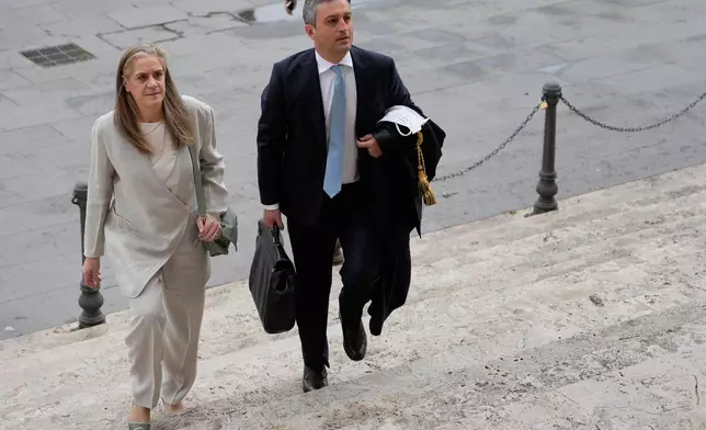 Italian lawyers Marco Mellone, right, and Graziella Cerulli arrive at Italy's highest Court of Cassation, in Rome, Tuesday, April 14, 2026, to argue against the new citizenship law that restricts citizenship by descent. (AP Photo/Gregorio Borgia)
