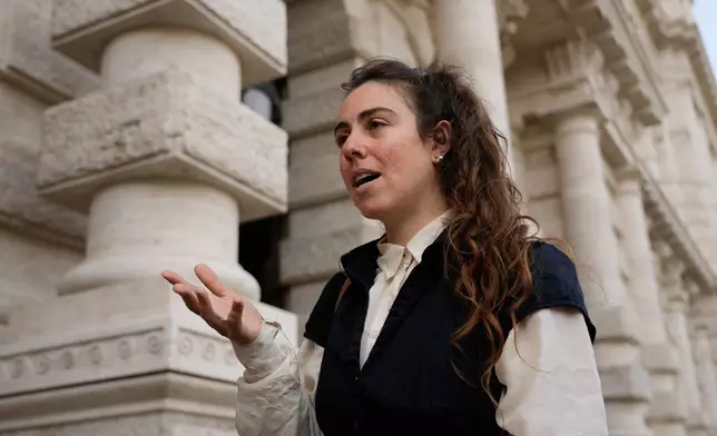 Alexis Traino, from the United States, is interviewed by the Associated Press outside Italy's highest Court of Cassation, in Rome, Tuesday, April 14, 2026, prior to the start of a hearing to argue against the new citizenship law that restricts citizenship by descent. (AP Photo/Gregorio Borgia)