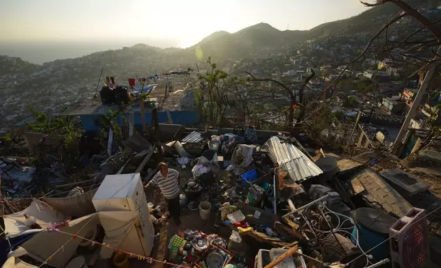 FILE - Jaime Sosa stands amid the ruins of his home nearly three weeks after Hurricane Otis hit as a Category 5 storm in the Alta Cuauhtemoc area of Acapulco, Mexico, Nov. 9, 2023. (AP Photo/Marco Ugarte, File)