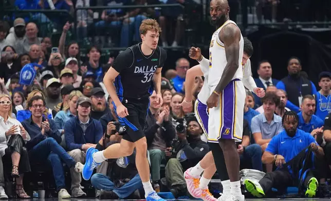 Dallas Mavericks forward Cooper Flagg (32) runs past Los Angeles Lakers forward LeBron James (23) during the first half of an NBA basketball game in Dallas, Sunday, April 5, 2026. (AP Photo/LM Otero)