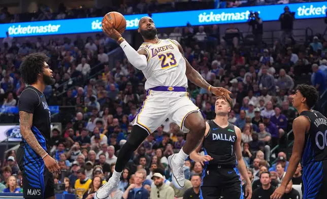 Los Angeles Lakers forward LeBron James (23) drives to the basket against Dallas Mavericks defenders John Poulakidas (1), Max Christie (00) and Naji Marshall during the first half of an NBA basketball game in Dallas, Sunday, April 5, 2026. (AP Photo/LM Otero)
