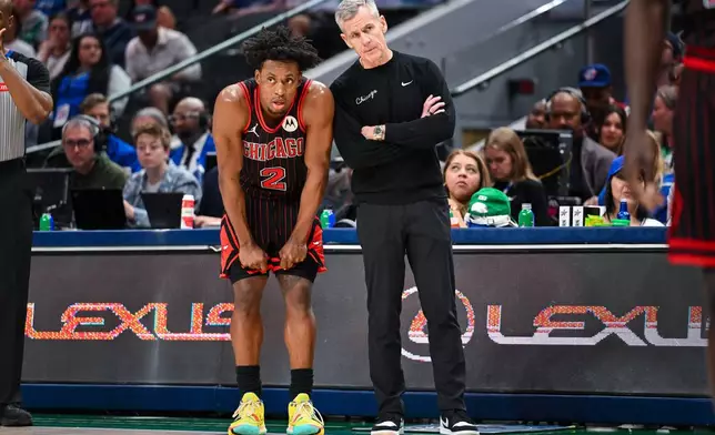 Chicago Bulls' Collin Sexton talks with Chicago Bulls head coach Billy Donovan during a time out in an NBA basketball game against the Dallas Mavericks Sunday, April 12, 2026, in Dallas. (AP Photo/Albert Pena)