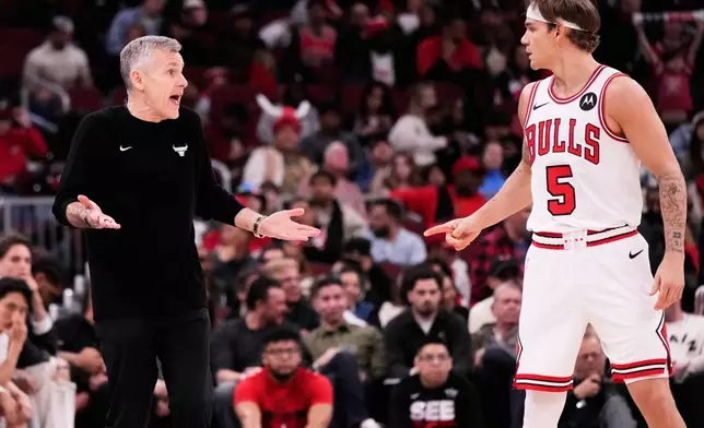 Chicago Bulls head coach Billy Donovan, left, talks with guard Mac McClung (5) during the second half of an NBA basketball game against the Orlando Magic in Chicago, Friday, April 10, 2026. (AP Photo/Nam Y. Huh)