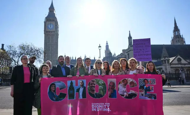 Campaigners hold a banner outside parliament in London as a proposed law to legalise assisted dying in England and Wales will run out of time on Friday, more than a year after MPs first voted in favour of it, Friday, April 24, 2026. (AP Photo/Kirsty Wigglesworth)