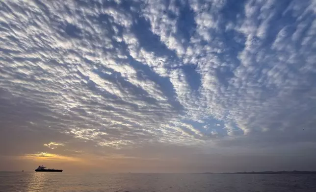 FILE - The sun rises behind a tanker anchored in the Strait of Hormuz off the coast of Qeshm Island, Iran, Saturday, April 18, 2026. (AP Photo/Asghar Besharati, File)