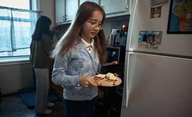 Gulhayo Yuldosheva's daughters have breakfast in an apartment building where tenants report maintenance issues and pest infestations, in the Bronx borough of New York, Tuesday, March 17, 2026. (AP Photo/Andres Kudacki)