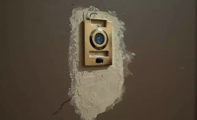 A broken peephole in an apartment building where tenants report maintenance issues and pest infestations, in the Bronx borough of New York, Tuesday, March 17, 2026. (AP Photo/Andres Kudacki)