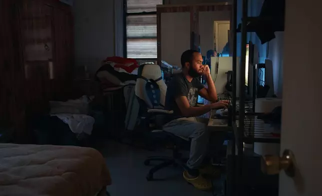 Marina Quiroz's son uses his computer in an apartment building where tenants report maintenance issues and pest infestations, in the Bronx borough of New York, Tuesday, March 17, 2026. (AP Photo/Andres Kudacki)