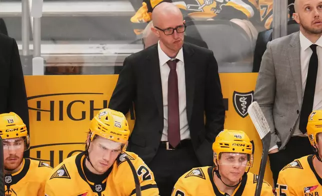Pittsburgh Penguins head coach Dan Muse, center top, stands behind his bench during the third period of Game 2 in the first round of the NHL Stanley Cup playoffs against the Philadelphia Flyers in Pittsburgh, Monday, April 20, 2026. (AP Photo/Gene J. Puskar)