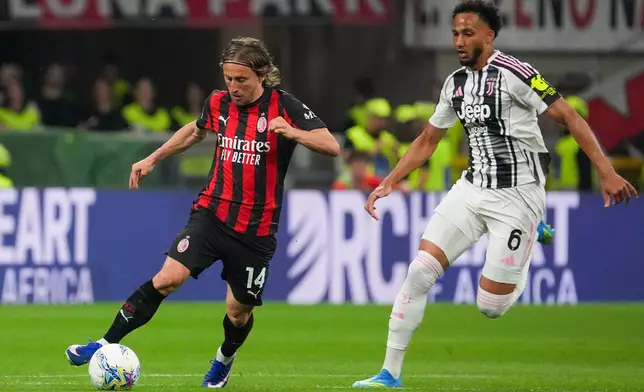 AC Milan's Luka Modric, left, controls the ball from Juventus' Lloyd Kelly during a Serie A soccer match between AC Milan and Juventus, in Milan, Italy, Sunday, April 26, 2026. (Alessio Morgese/LaPresse via AP)