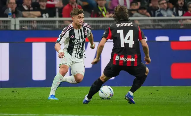 Juventus's Francisco Conceicao, left, fights for the ball with AC Milan's Luka Modric during the Serie A soccer match between AC Milan and Juventus, in Milan, Italy, Sunday, April 26, 2026. (Alessio Morgese/LaPresse via AP)