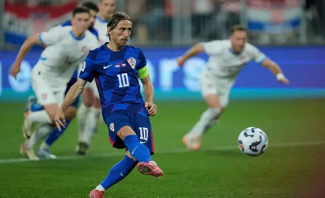 FILE - Croatia's Luka Modric scores his side's second goal from a penalty spot during a World Cup 2026 group L qualifying soccer match between Croatia and Czech Republic at the Opus Arena in Osijek, Croatia, Monday, June 9, 2025. (AP Photo/Darko Bandic, File)