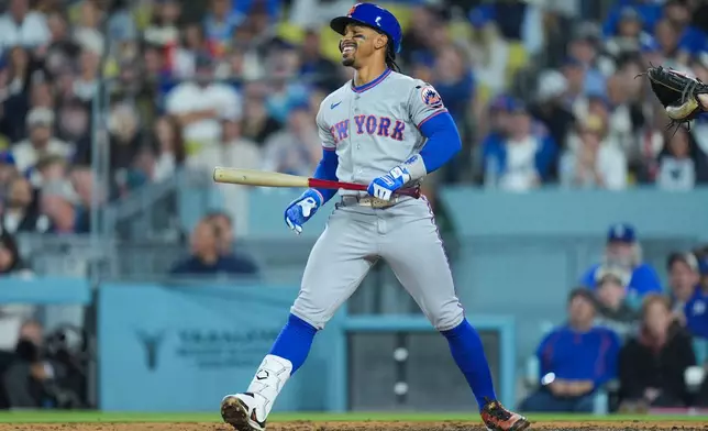 New York Mets' Francisco Lindor reacts after striking out during the third inning of a baseball game against the Los Angeles Dodgers Wednesday, April 15, 2026, in Los Angeles. (AP Photo/Jae C. Hong)