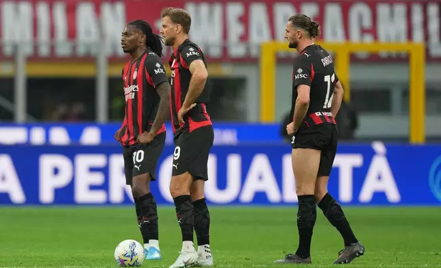 AC Milan players stand dejected after conceiding a goal during the Serie A soccer match between AC Milan and Udinese, in Milan, Italy, Saturday, April 11, 2026. (AP Photo/Antonio Calanni)