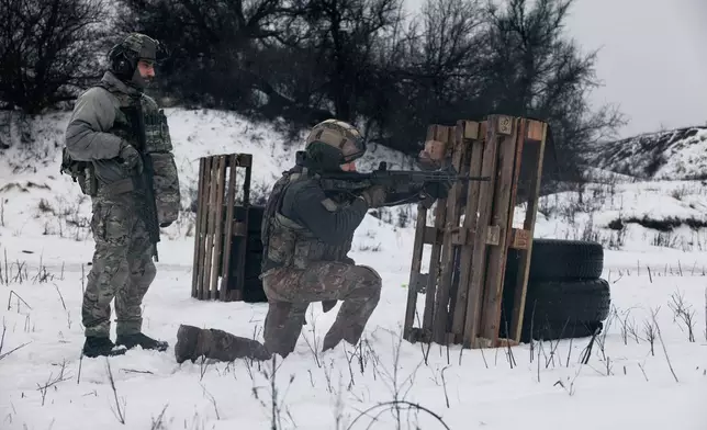 Soldiers from Ukraine's Khartia brigade practice shooting at a training ground in the Kharkiv region, Ukraine, Feb. 14, 2026. (AP Photo/Nikoletta Stoyanova)