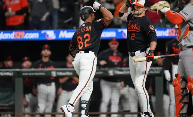Baltimore Orioles' Jeremiah Jackson (82) celebrates with Gunnar Henderson (2) after hitting a home run during the seventh inning of a baseball game against the San Francisco Giants, Saturday, April 11, 2026, in Baltimore. (AP Photo/Stephanie Scarbrough)