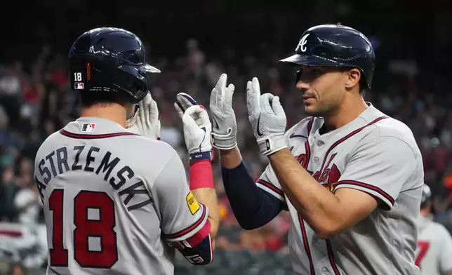 Atlanta Braves' Matt Olson celebrates with Mike Yastrzemski (18) after hitting a solo home run against the Arizona Diamondbacks in the first inning of a baseball game, Thursday, April 2, 2026, in Phoenix. (AP Photo/Rick Scuteri)