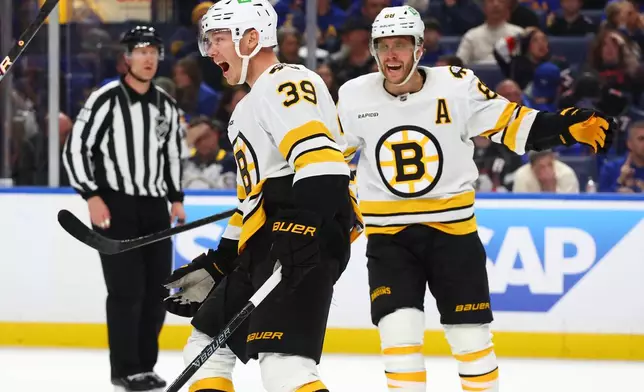 Boston Bruins center Morgan Geekie (39) celebrates his goal with right wing David Pastrnak (88) during the second period in Game 2 of a first-round NHL hockey Stanley Cup playoff series against the Buffalo Sabres Tuesday, April 21, 2026, in Buffalo, N.Y. (AP Photo/Jeffrey T. Barnes)