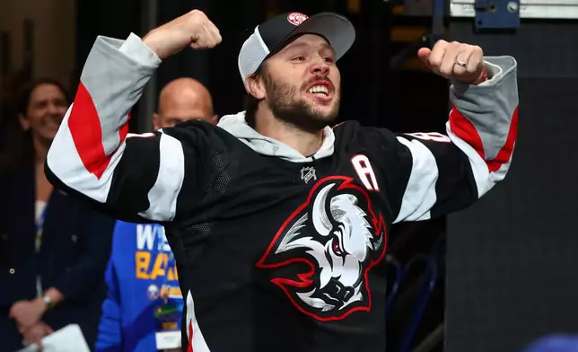 Buffalo Bills quarterback Josh Allen hypes the crowd prior to the first period in Game 2 of a first-round NHL hockey Stanley Cup playoff series between the Buffalo Sabres and Boston Bruins Tuesday, April 21, 2026, in Buffalo, N.Y. (AP Photo/Jeffrey T. Barnes)