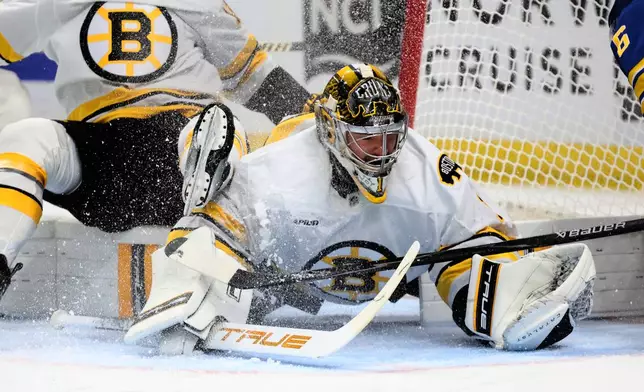 Boston Bruins goaltender Jeremy Swayman (1) makes a save in traffic during the first period in Game 2 of a first-round NHL hockey Stanley Cup playoff series against the Buffalo Sabres Tuesday, April 21, 2026, in Buffalo, N.Y. (AP Photo/Jeffrey T. Barnes)
