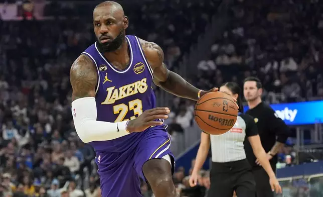 Los Angeles Lakers forward LeBron James (23) drives to the basket against the Golden State Warriors during the first half of an NBA basketball game in San Francisco, Thursday, April 9, 2026. (AP Photo/Jeff Chiu)
