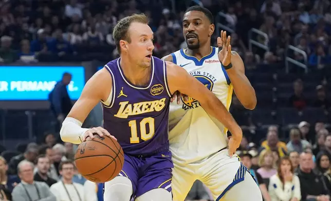 Los Angeles Lakers guard Luke Kennard (10) drives to the basket against Golden State Warriors guard De'Anthony Melton during the first half of an NBA basketball game in San Francisco, Thursday, April 9, 2026. (AP Photo/Jeff Chiu)