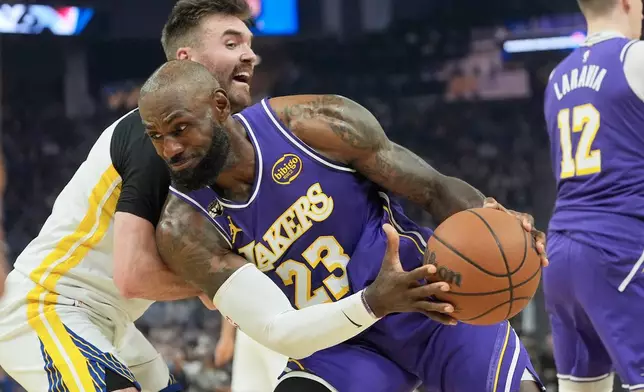 Los Angeles Lakers forward LeBron James (23) drives to the basket against Golden State Warriors guard Pat Spencer during the first half of an NBA basketball game in San Francisco, Thursday, April 9, 2026. (AP Photo/Jeff Chiu)