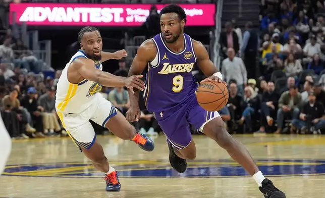 Los Angeles Lakers guard Bronny James (9) drives to the basket against Golden State Warriors guard LJ Cryer during the first half of an NBA basketball game in San Francisco, Thursday, April 9, 2026. (AP Photo/Jeff Chiu)
