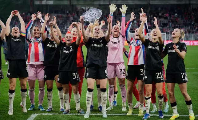 Munich players celebrate winning the German championship after a German women's Bundesliga soccer match between 1.FC Union Berlin and Bayern Munich in Berlin, Germany, Wednesday, April 22, 2026. (AP Photo/Ebrahim Noroozi)