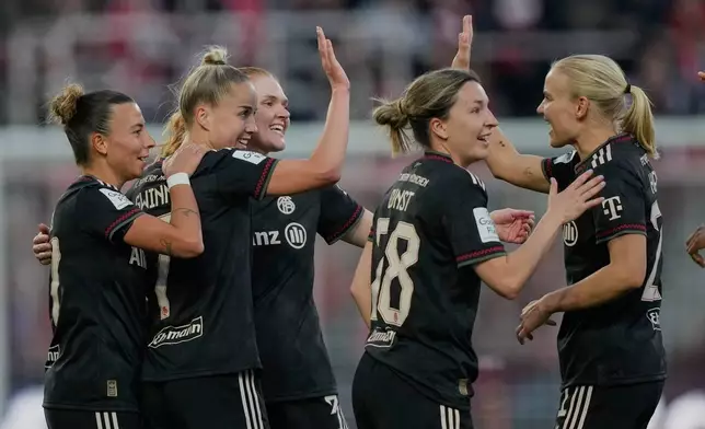 Bayern players celebrate their side's third goal during a German women's Bundesliga soccer match between 1.FC Union Berlin and Bayern Munich in Berlin, Germany, Wednesday, April 22, 2026. (AP Photo/Ebrahim Noroozi)