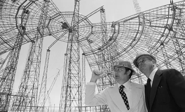 FILE - New York Mets general manager Robert Scheffing, right, chats with stadium official Bill Connick under the roof of the dome stadium that is under construction in New Orleans, April 2, 1973. (AP Photo/Jack Thornell, File)