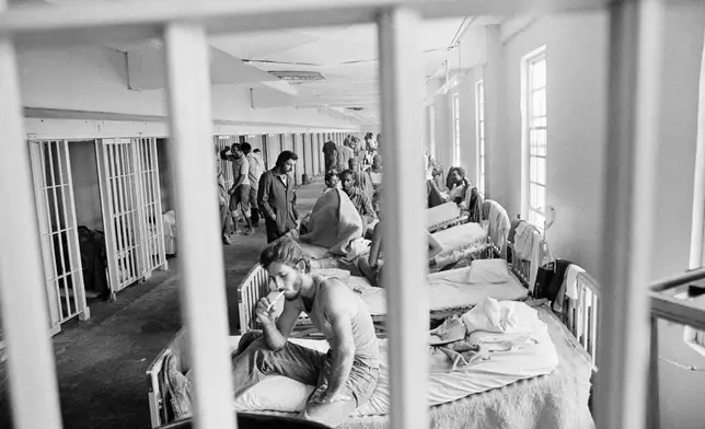 FILE - A prisoner lights a cigarette in the maximum security section of the Louisiana State prison at Angola, in December 1975. (AP Photo/Jack Thornell, File)