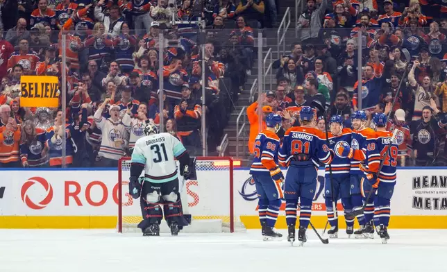Seattle Kraken goalie Philipp Grubauer (31) looks on as the Edmonton Oilers celebrate a goal during first period NHL action, in Edmonton on Tuesday, March 31, 2026. (Jason Franson/The Canadian Press via AP)