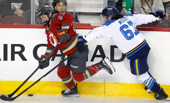 Toronto Sceptres' Renata Fast, right, is knocked down by Ottawa Charge's Fanuza Kadirova during first period PWHL Takeover Tour hockey game in Calgary, on Wednesday, April 1, 2026. (Larry MacDougal/The Canadian Press via AP)