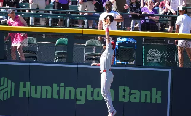 Philadelphia Phillies left fielder Brandon Marsh pulls in a fly ball off the bat of Colorado Rockies pinch-hitter Kyle Karros in the seventh inning of a baseball game Sunday, April 5, 2026, in Denver. (AP Photo/David Zalubowski)